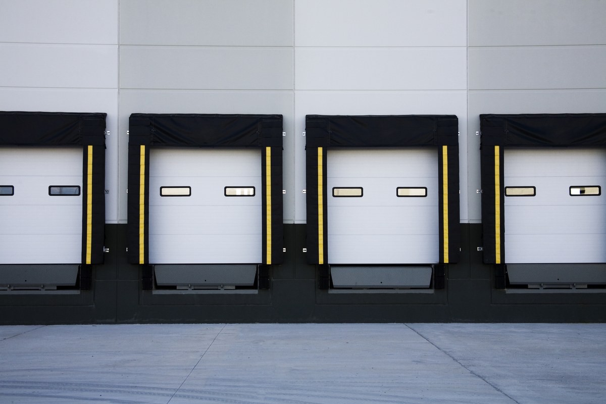 Industrial loading dock seals with yellow safety stripes at a distribution center